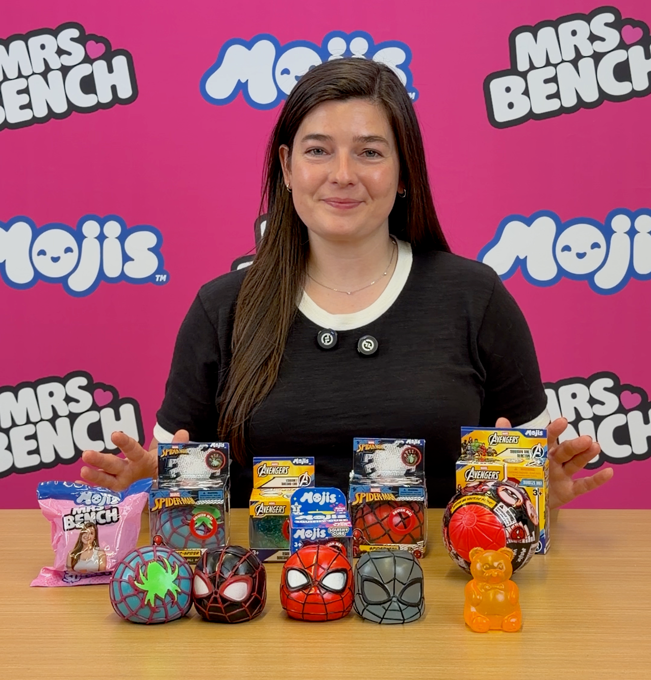 Mrs. Bench with a lineup of Mojis squishy characters and packaged collectibles.